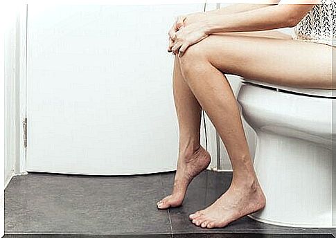 Woman sitting on the toilet