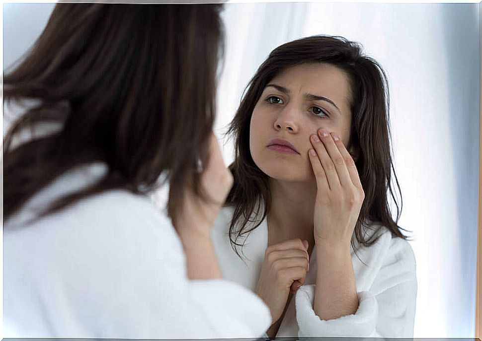 Woman mirror tired eyes.