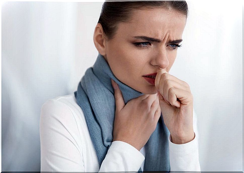 Woman with sore throat coughs