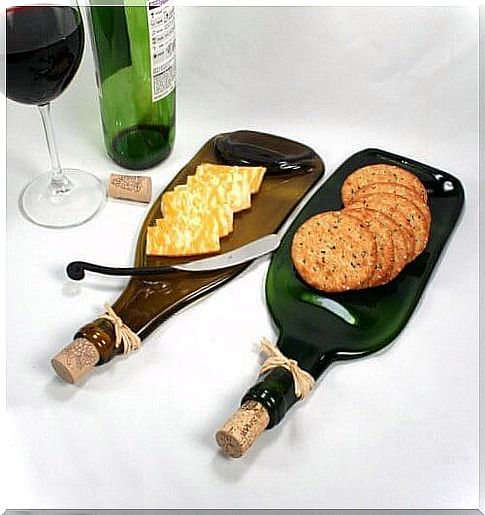 cutting board with glass bottle and appetizers