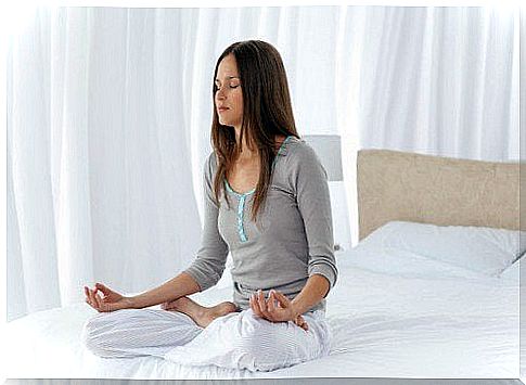 Woman meditating on the bed