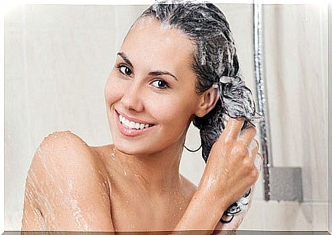 Woman with shampoo in the shower