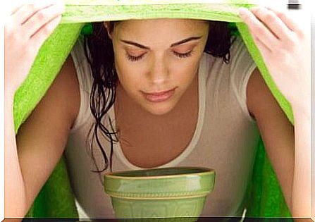 Woman inhaling the steam to clear the airways.