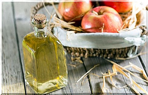 apple cider vinegar and basket with red apples