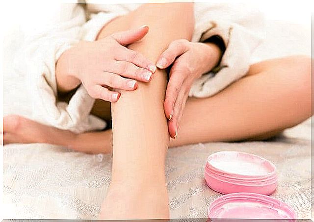 Uses of Vaseline: Woman spreads the cream on her legs.